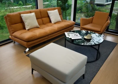 BAUSTADT Capsule House Model E8 living room interior with modern sofa and panoramic window