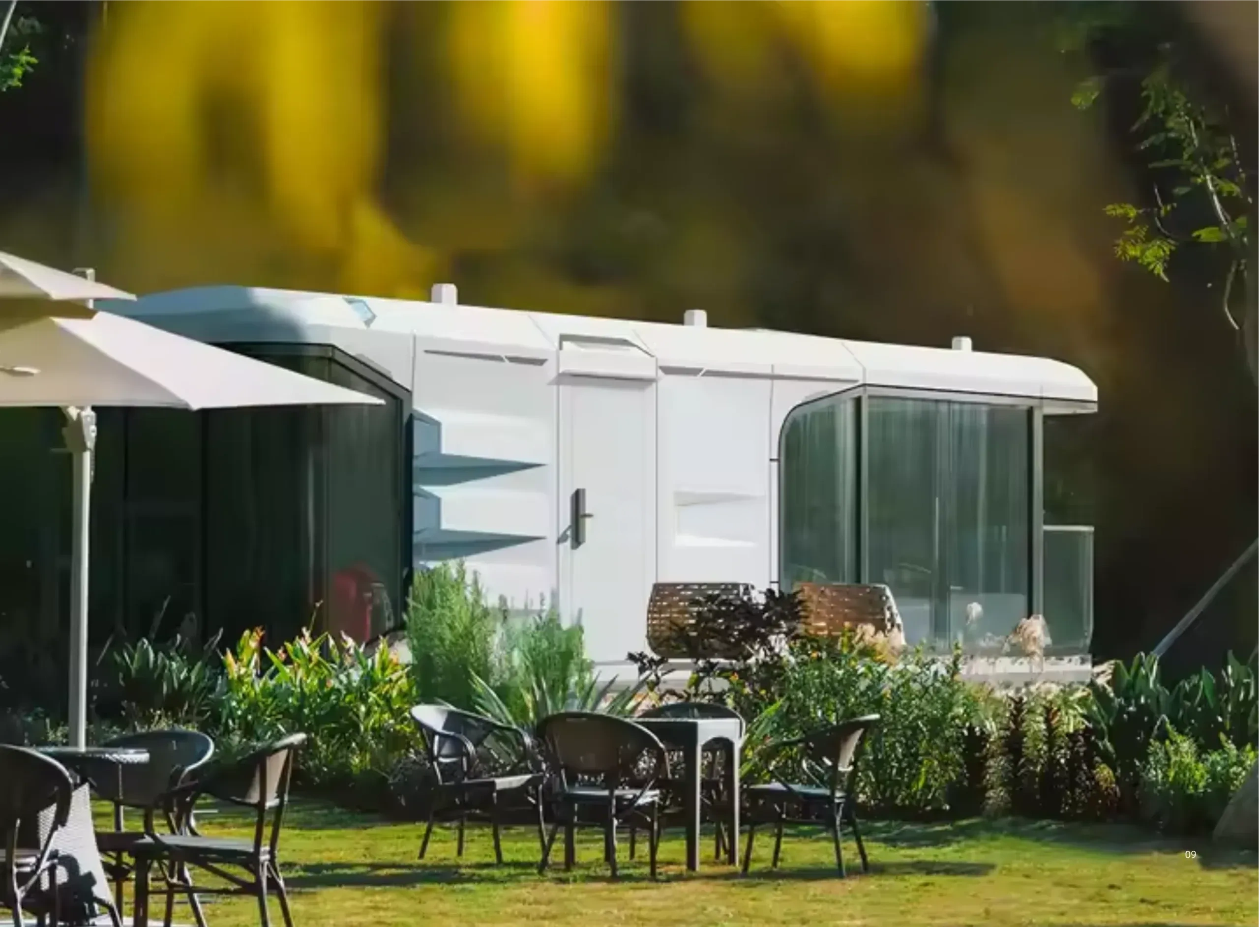 BAUSTADT G70 space capsule house exterior in garden setting with panoramic glass facade