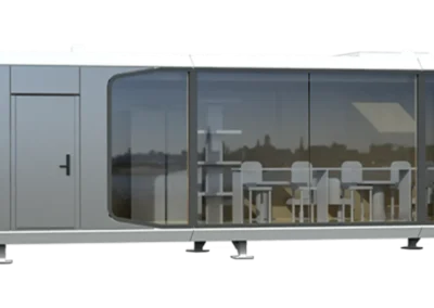BAUSTADT Space Capsule House A50 side view with full glass wall and visible modern dining interior